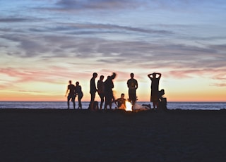 group of people setting up campfire