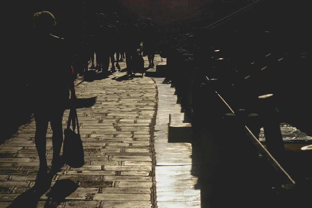 silhouette photography of woman passing through bridge