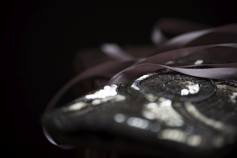 a close up of a black and silver purse