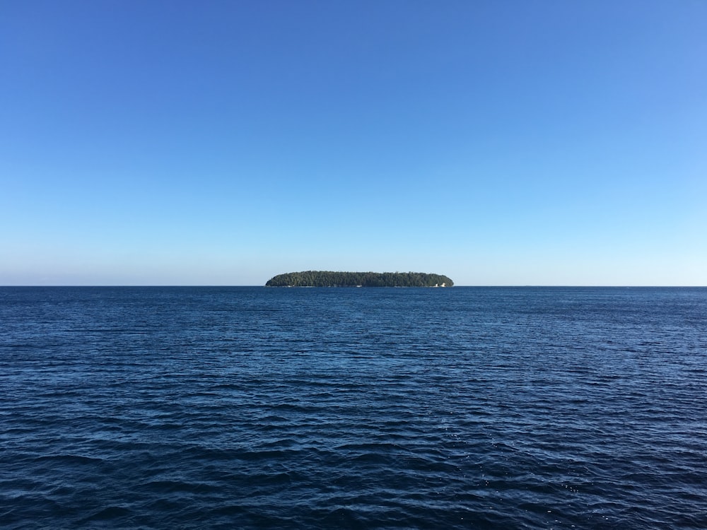 island surrounded by body of water during daytime