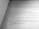 A close-up view of a book page displaying structured code written in a programming language, likely Java. The text is oriented diagonally, capturing sections of code including a method definition and exception handling.