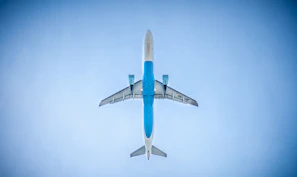 low angle photography of blue commercial airplane