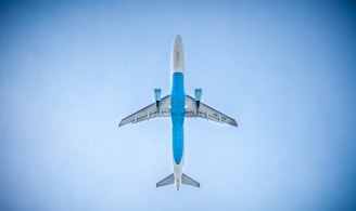 low angle photography of blue commercial airplane