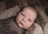 baby in brown swaddle