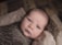 baby in brown swaddle