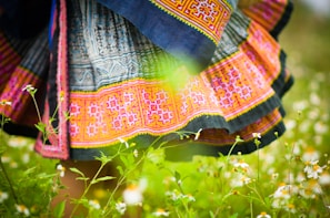 A flowing skirt with traditional patterns in white on a deep black fabric, capturing cultural heritage with a fresh twist.