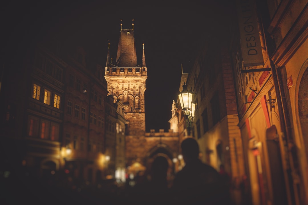 people standing near brown concrete tower,