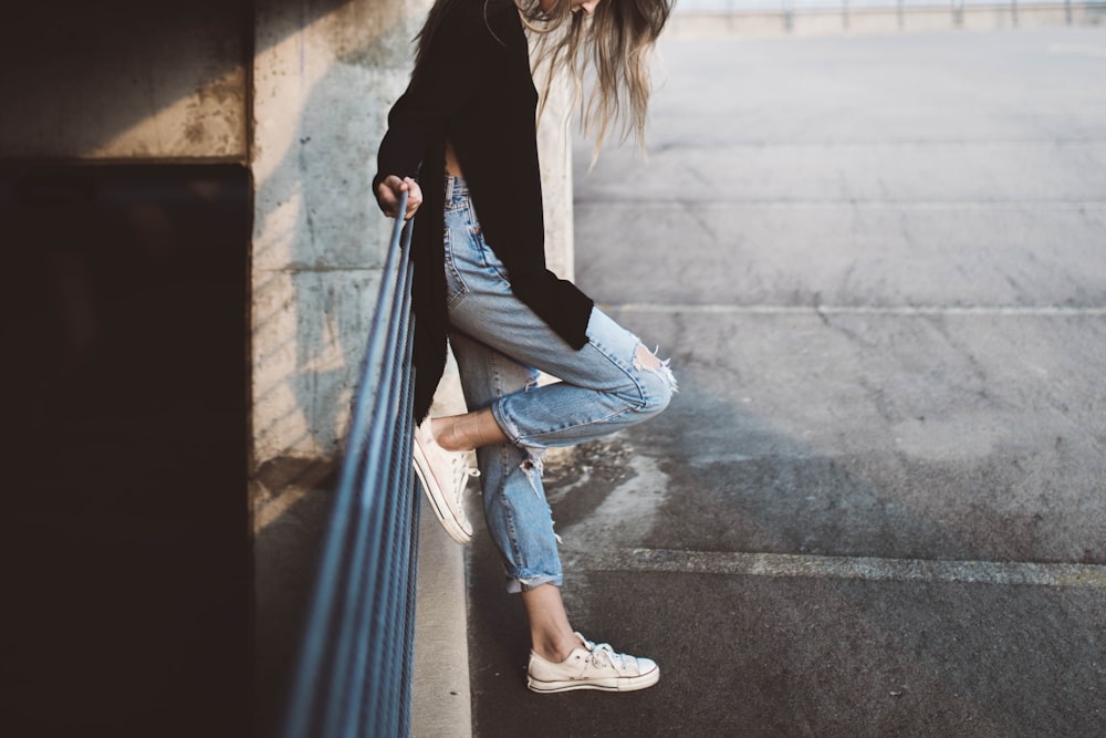 woman standing beside fence