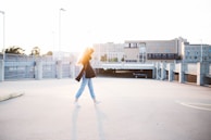 woman walking on road near building at daytime