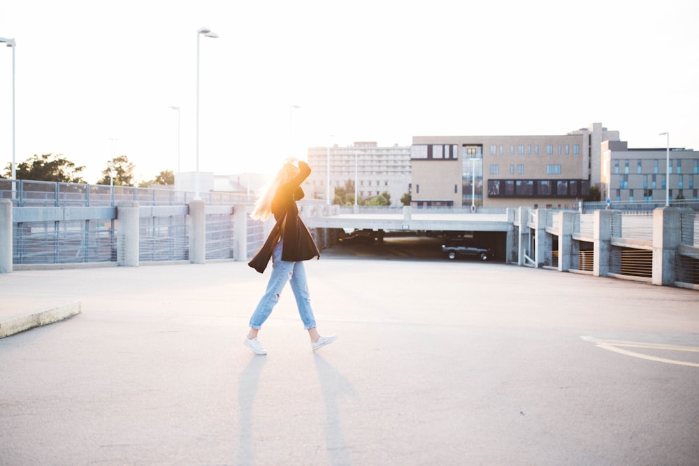 woman walking on road near building at daytime