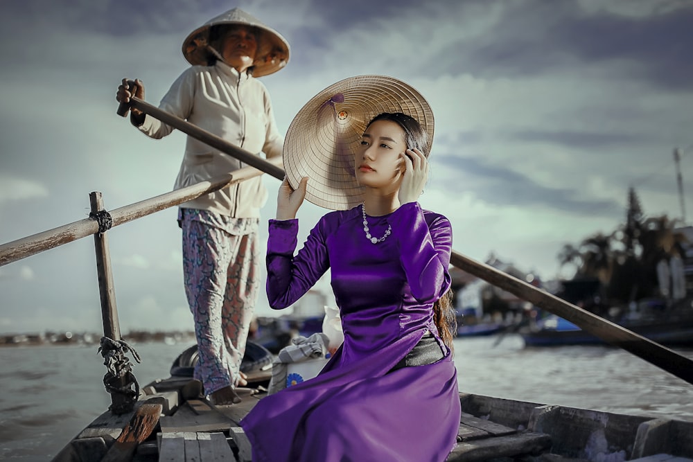 woman riding on boat rowed by standing woman