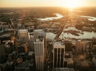 Aerial view of a city skyline with office towers at sunset.