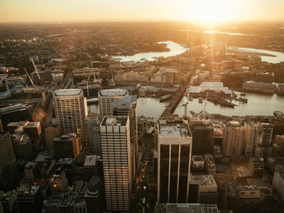 Aerial view of a modern cityscape captured by a drone during golden hour.