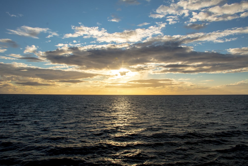 ocean under blue sky at golden houe