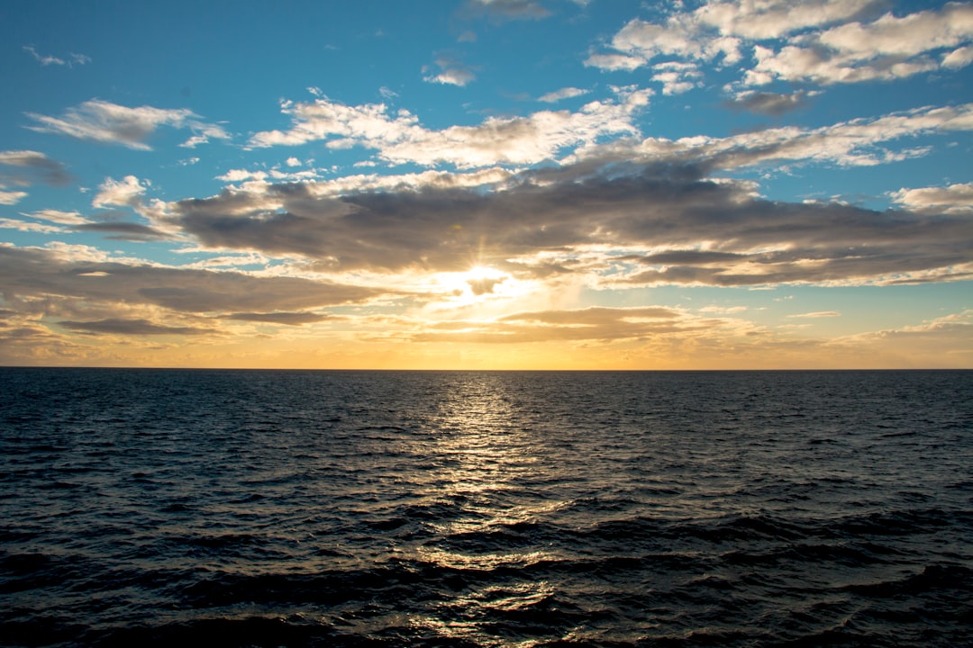 ocean under blue sky at golden houe