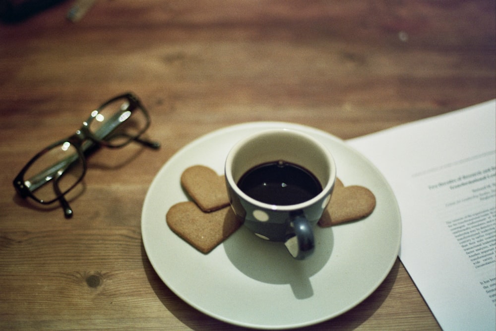 black and white polka-dot cup with brown liquid