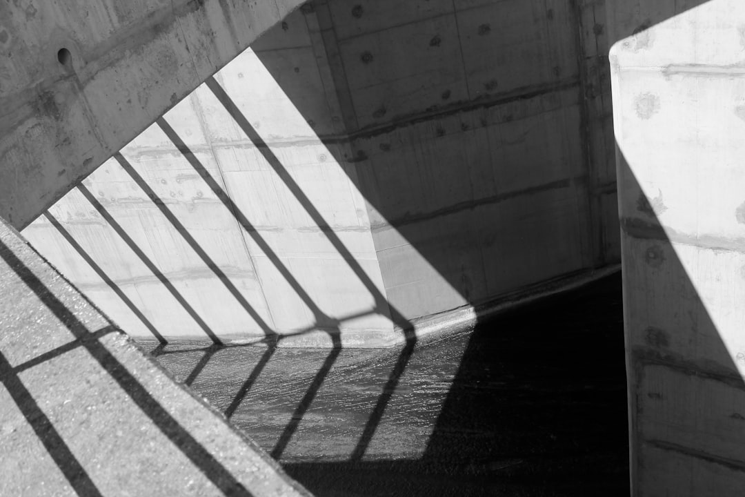 minimalist photography of gray wall with grill shadows