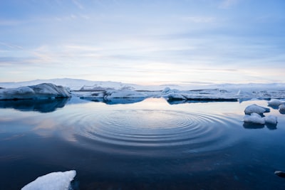 body of water between icebergs north pole teams background