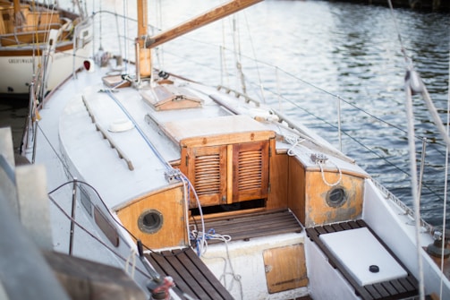 white and brown motorboat near dock