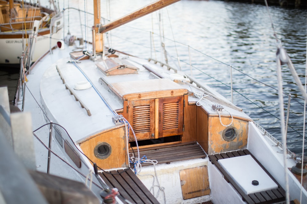 white and brown motorboat near dock