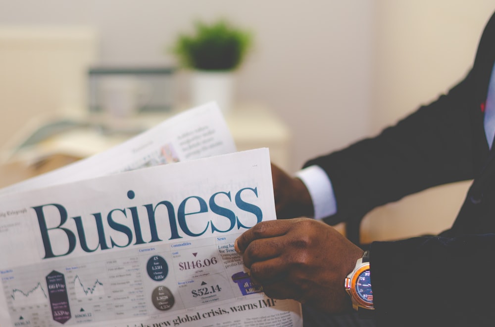 A businessman opening a business newspaper