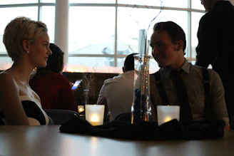 A smiling couple enjoying their meal in the softly lit dining area.