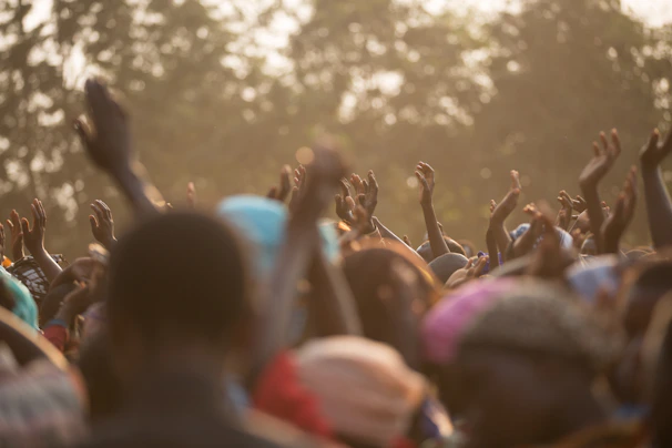 Hands raised in a group discussion, capturing the energy of connection.