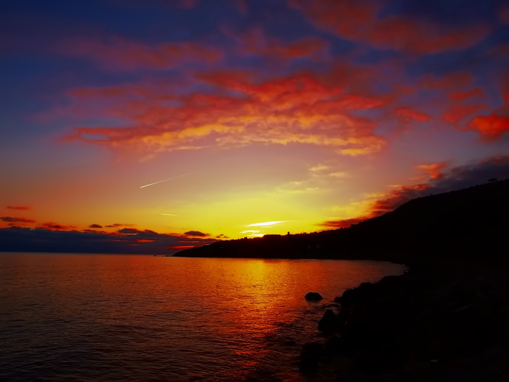 silhouette photo of island during golden hour