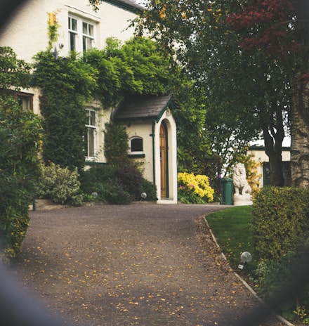 minimalist photography of house shot in front of chain fence