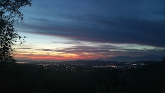 A scenic view of a Ukrainian sunset over a city skyline.