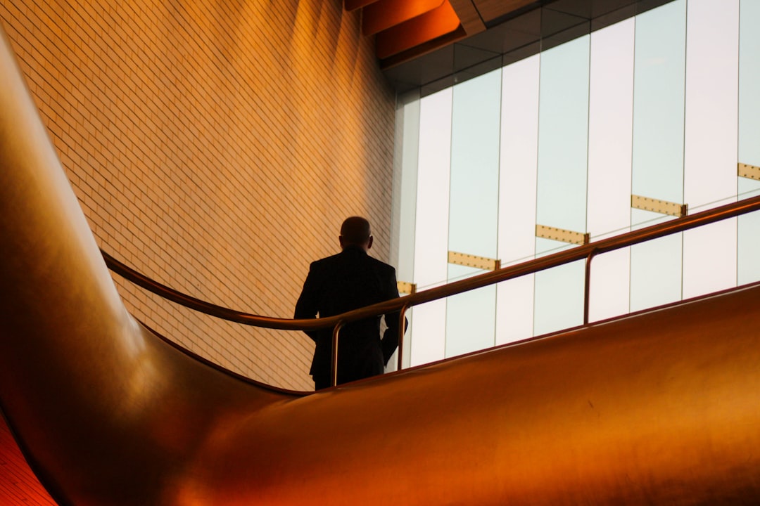 man standing on grill, Businessman on a staircase