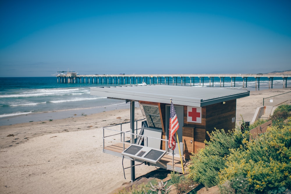 brown and gray shed near beach and port