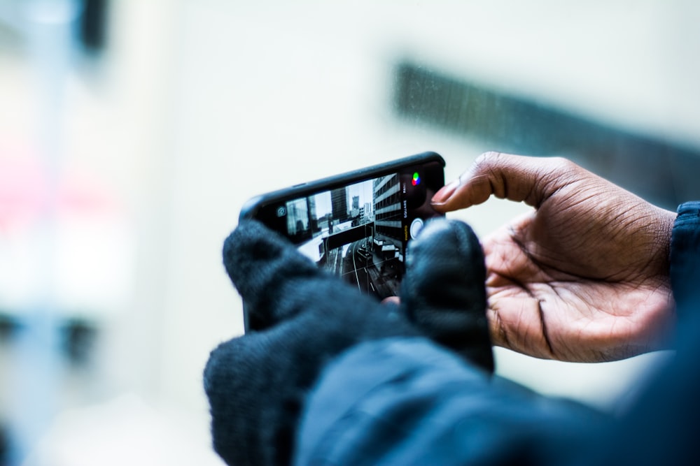 selective focus photography of person taking picture of the road