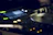 Close-up of a DJ console with glowing controls and dark ambient lighting.