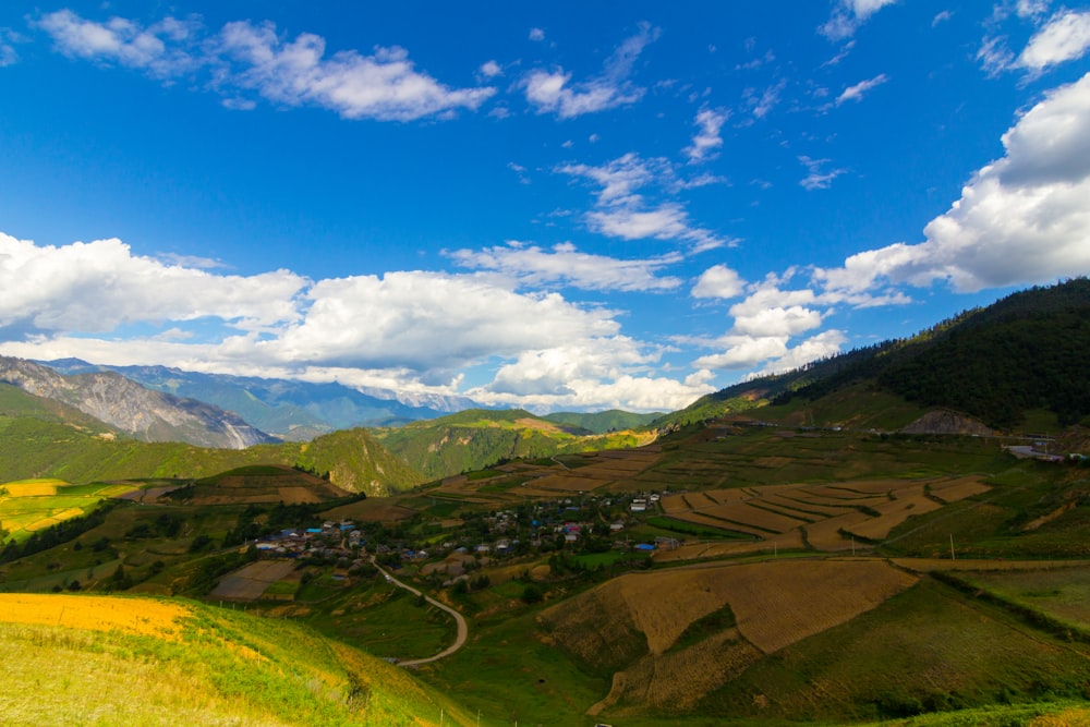 Rolling hills and fields against a blue sky