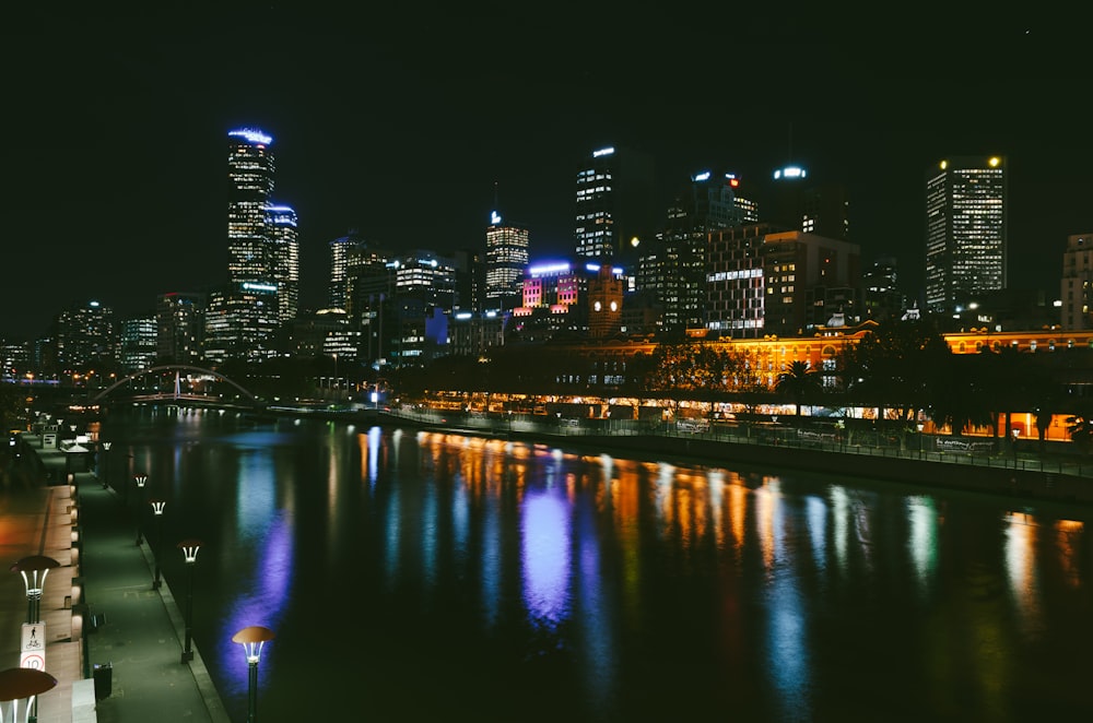 cityscape near canal with outdoor lamps under night sky