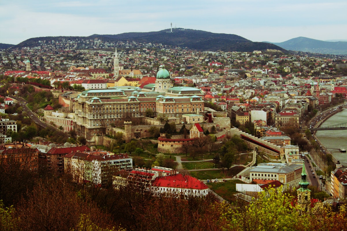 Budapest May — aerial view of the historic Buda Castle and city rooftops in spring sunshine