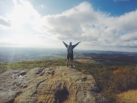 man standing on top of the mountain