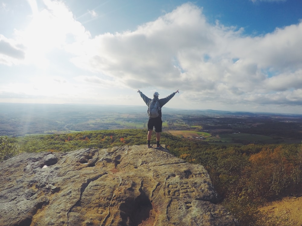 man standing on top of the mountain