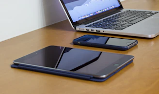 A sleek setup of laptops and tablets arranged on a modern event booth table.