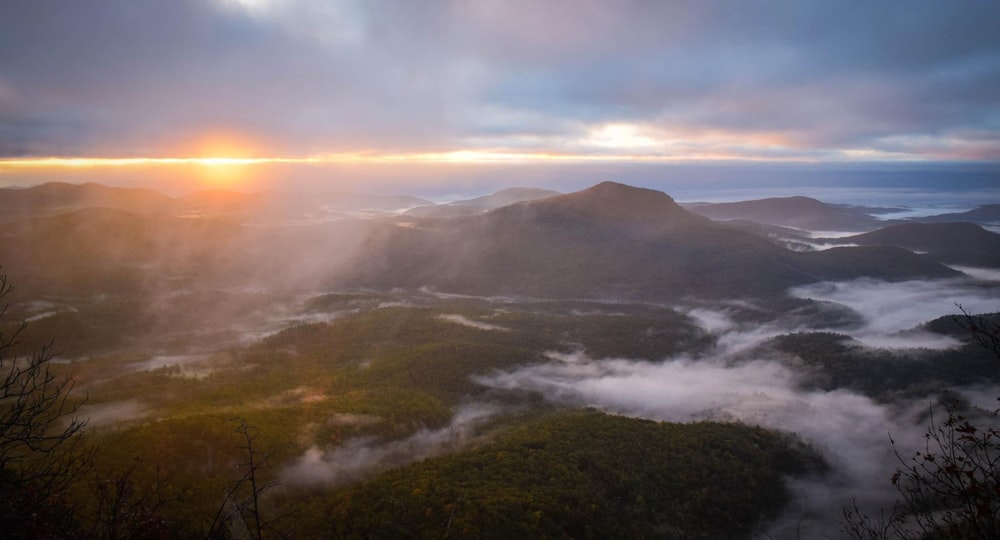 mountains with fog during daytime