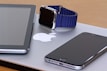 An array of modern tech gadgets on a wooden table.