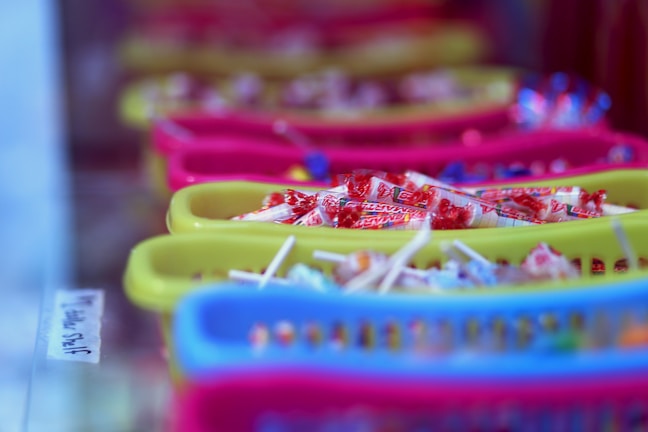 Close-up of colorful handmade sweets arranged on a rustic wooden table.