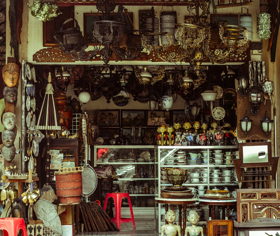 A wall of vintage lamps, lanterns and lighting fixtures in an antiques shop