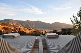sunloungers fronting buildings near mountain
