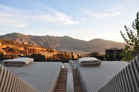 sunloungers fronting buildings near mountain