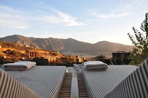 sunloungers fronting buildings near mountain