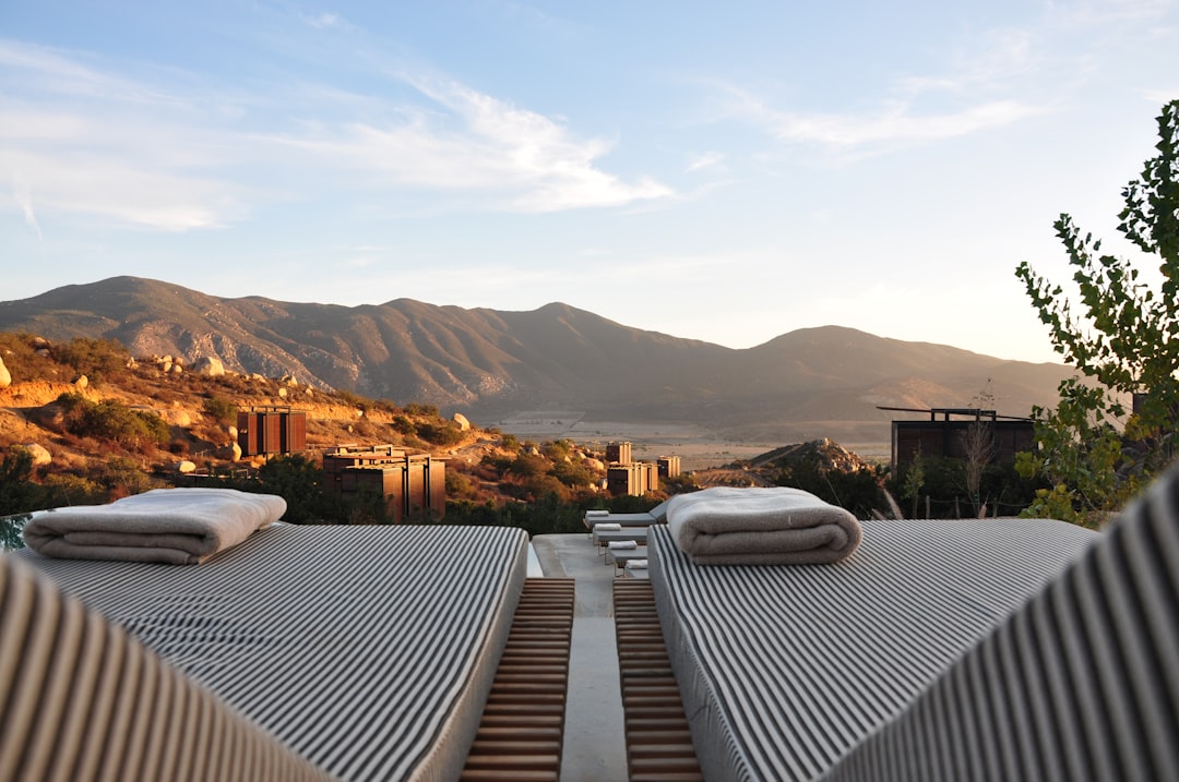 sunloungers fronting buildings near mountain, Deck chairs in the mountains