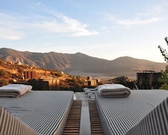 sunloungers fronting buildings near mountain