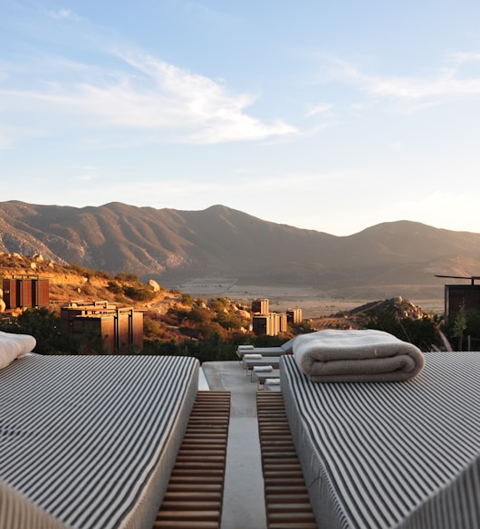 sunloungers fronting buildings near mountain